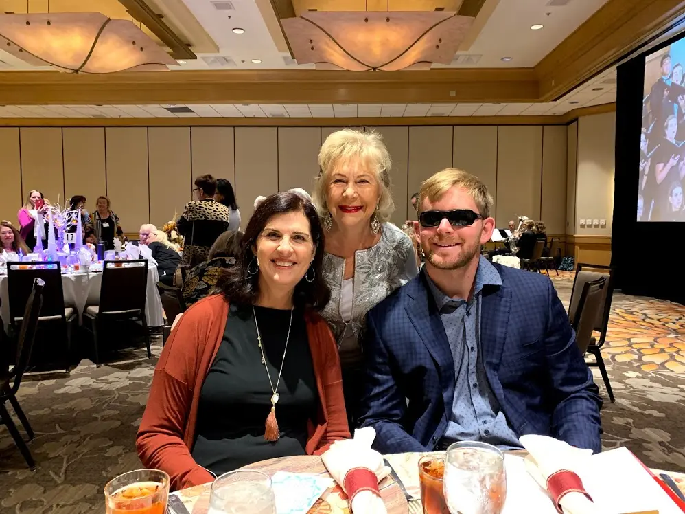 Two women and a man posing for a photo